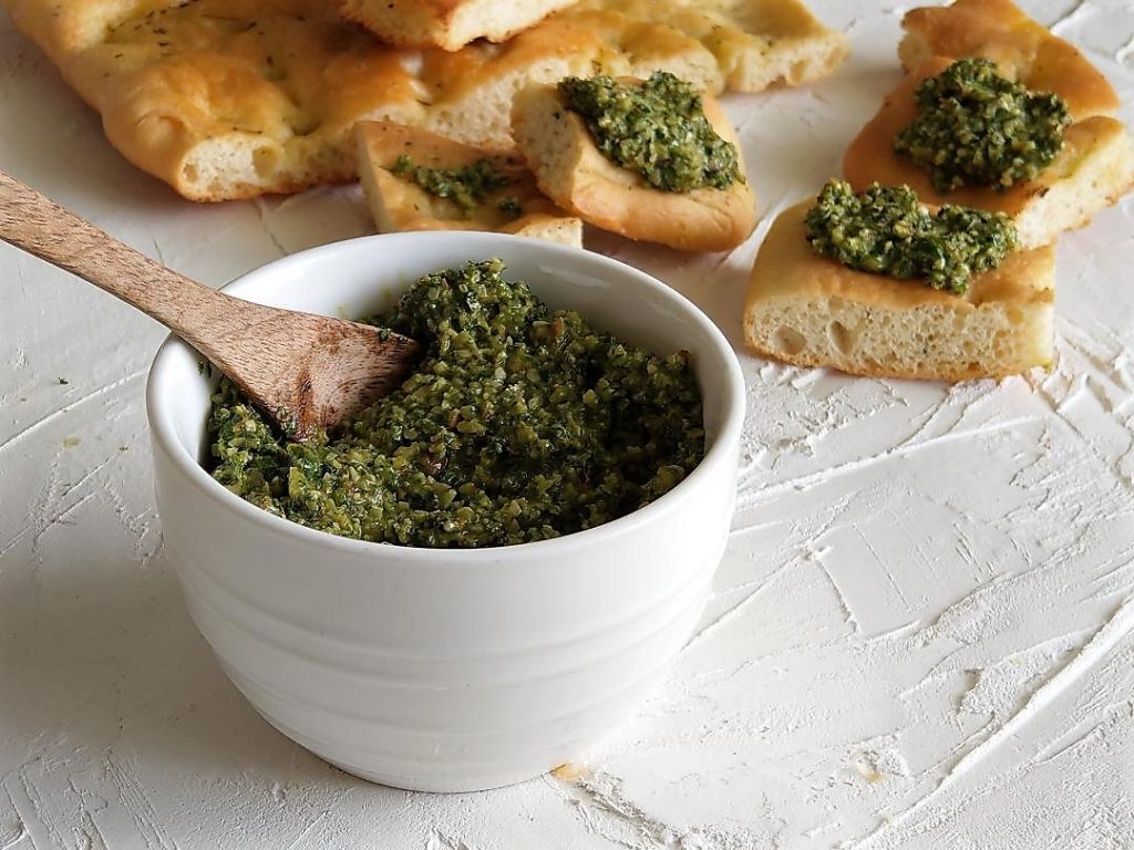 Almond Pesto Recipe with leafy green vegetables on Focaccia Bread