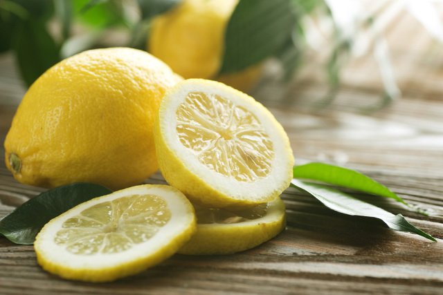 Fresh lemons on a wooden table.