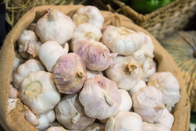 Stack of garlic in a sack bag