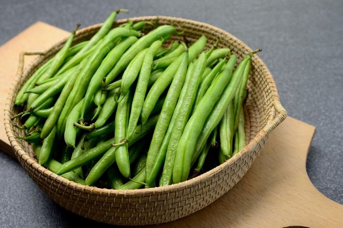 fresh green beans on a brown basket