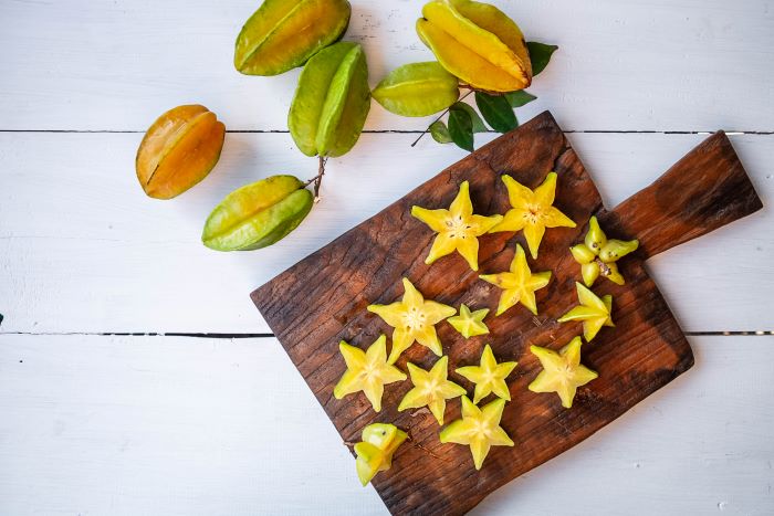Cut Slices of Star Fruit on a Board